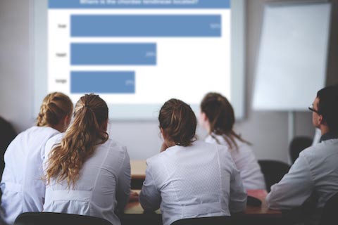 Medical students facing projector
